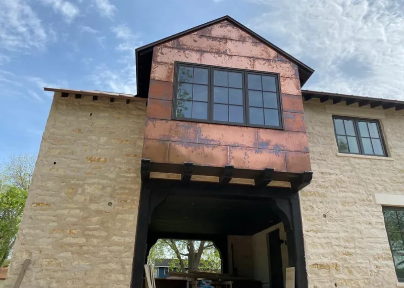 Copper metal panel facade on a stone building for Skylight Installation in Jensen Beach